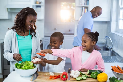 Happy family preparing food in kitchen